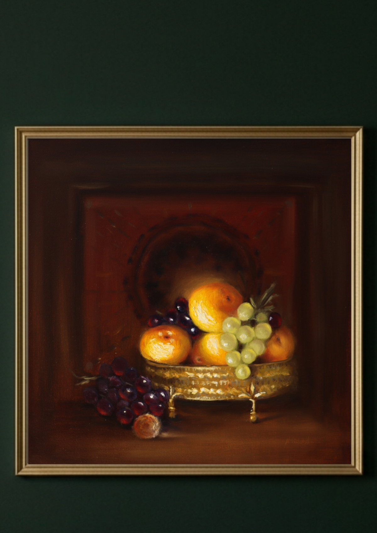 A framed still life painting of fruit, featuring peaches, grapes, and a small basket, displayed against a dark green wall.