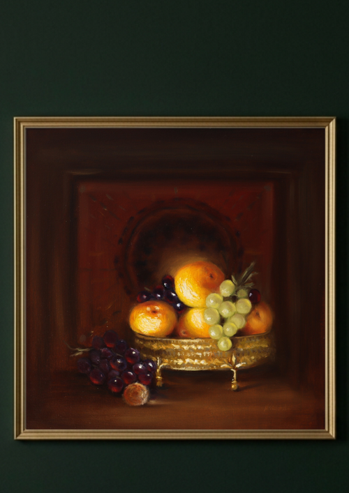 A framed still life painting of fruit, featuring peaches, grapes, and a small basket, displayed against a dark green wall.