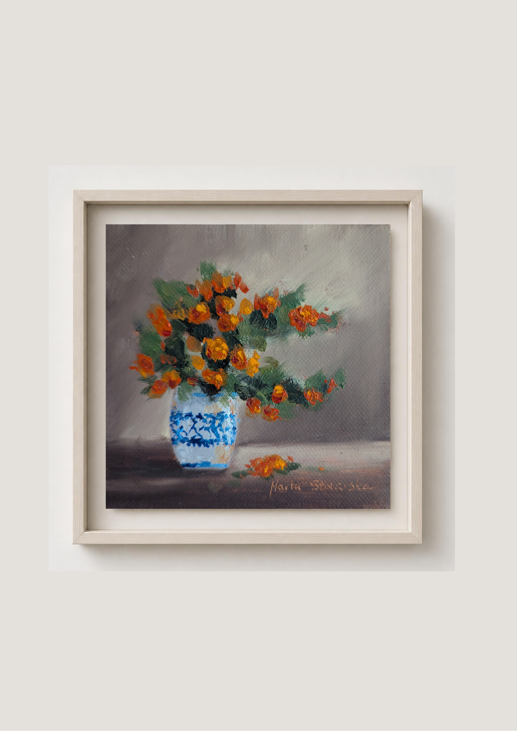 Oil painting of a bouquet of orange flowers in a blue and white vase on a gray background. Original oil painting of an autumnal trio of flowers or fruits, warm amber and rust tones still life