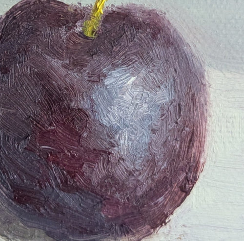 close up on the reflections of a juicy plum