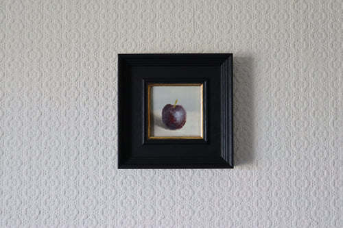 Small framed artwork of a purple plum on a textured wall. Original oil painting of blue reflections, light and colour l