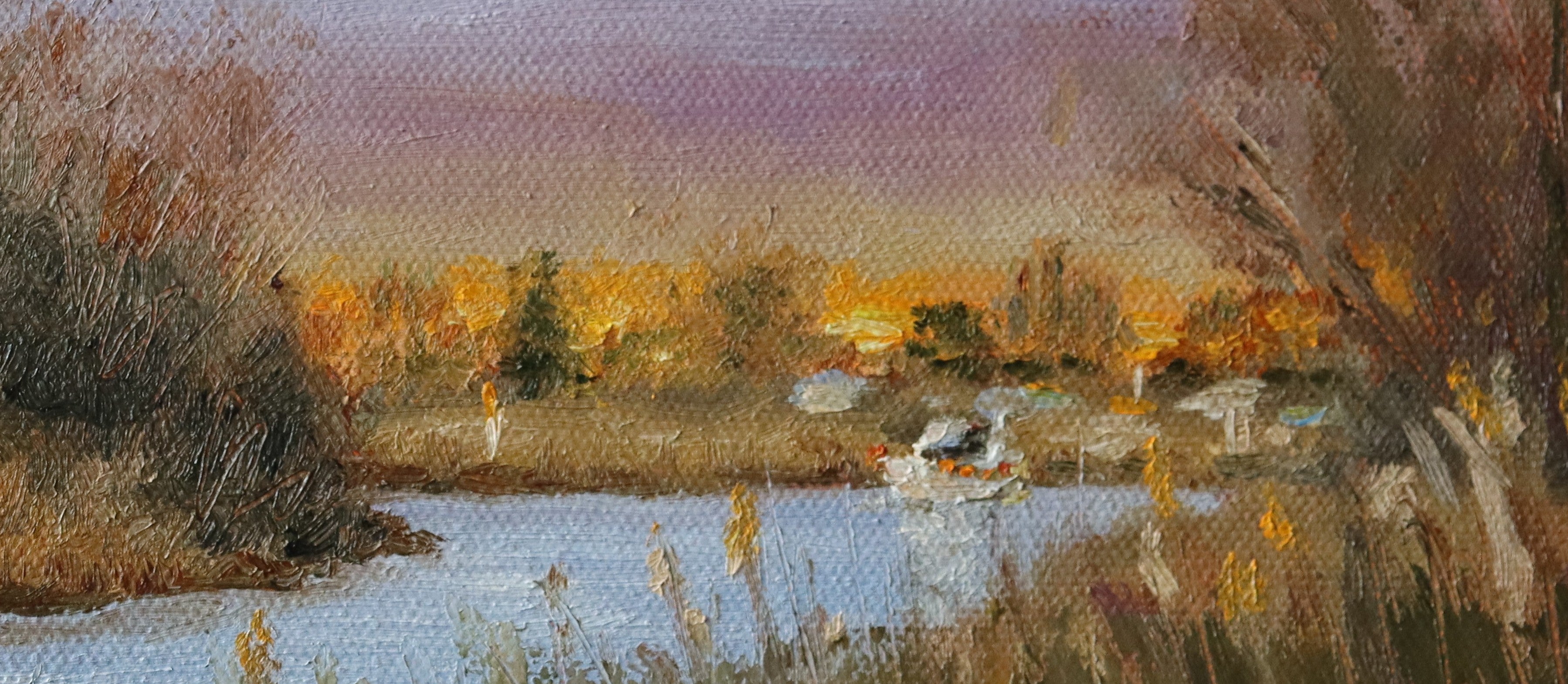 Painting of a landscape with a lake, trees, and a sunset. Original oil painting of boaters enjoying sunset at the Suffolk marshes, warm evening light on water by local artist