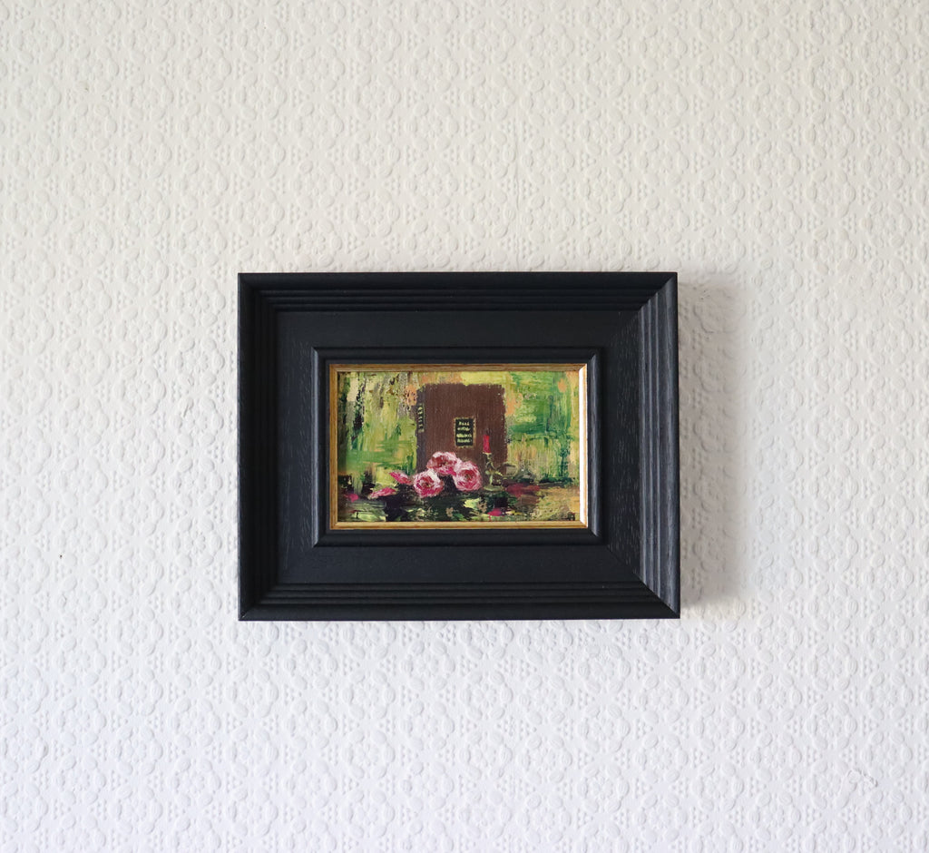 Framed Still life painting with pink flowers and a candle on a reflective surface. Original painting The Book of Spells, mysterious atmospheric artwork by Marta Stolarska Fine Art 