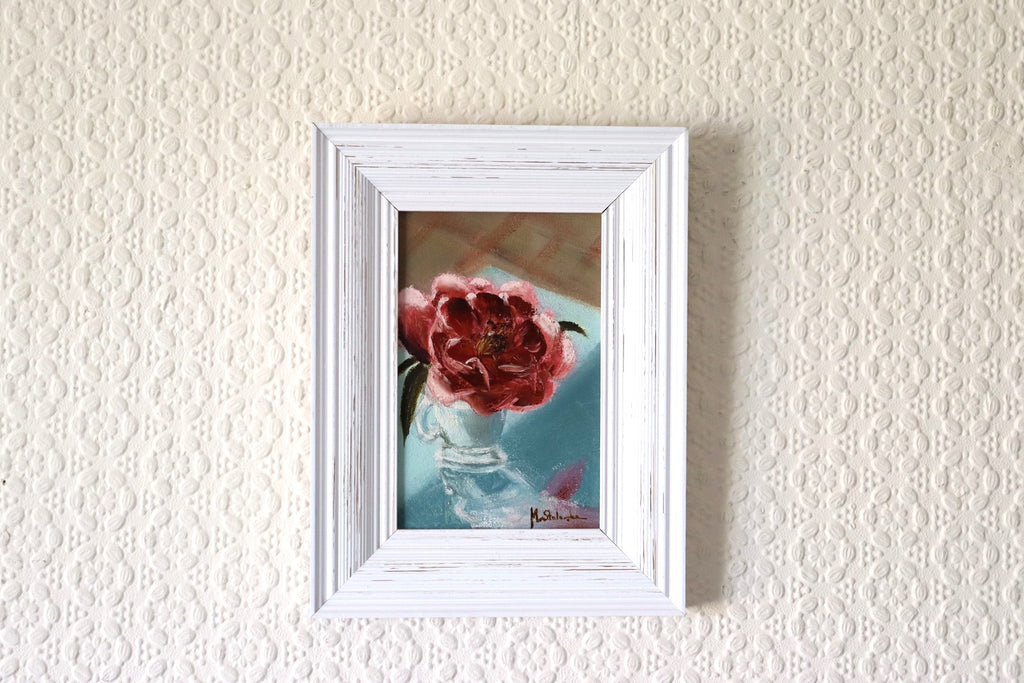 Camellia in an Espresso Cup original oil painting hung on a wall - pink camellia in glass cup in modern white wooden frame, approx. 18.5 x 23.5 cm, by Marta Stolarska Fine Art, ready to hang