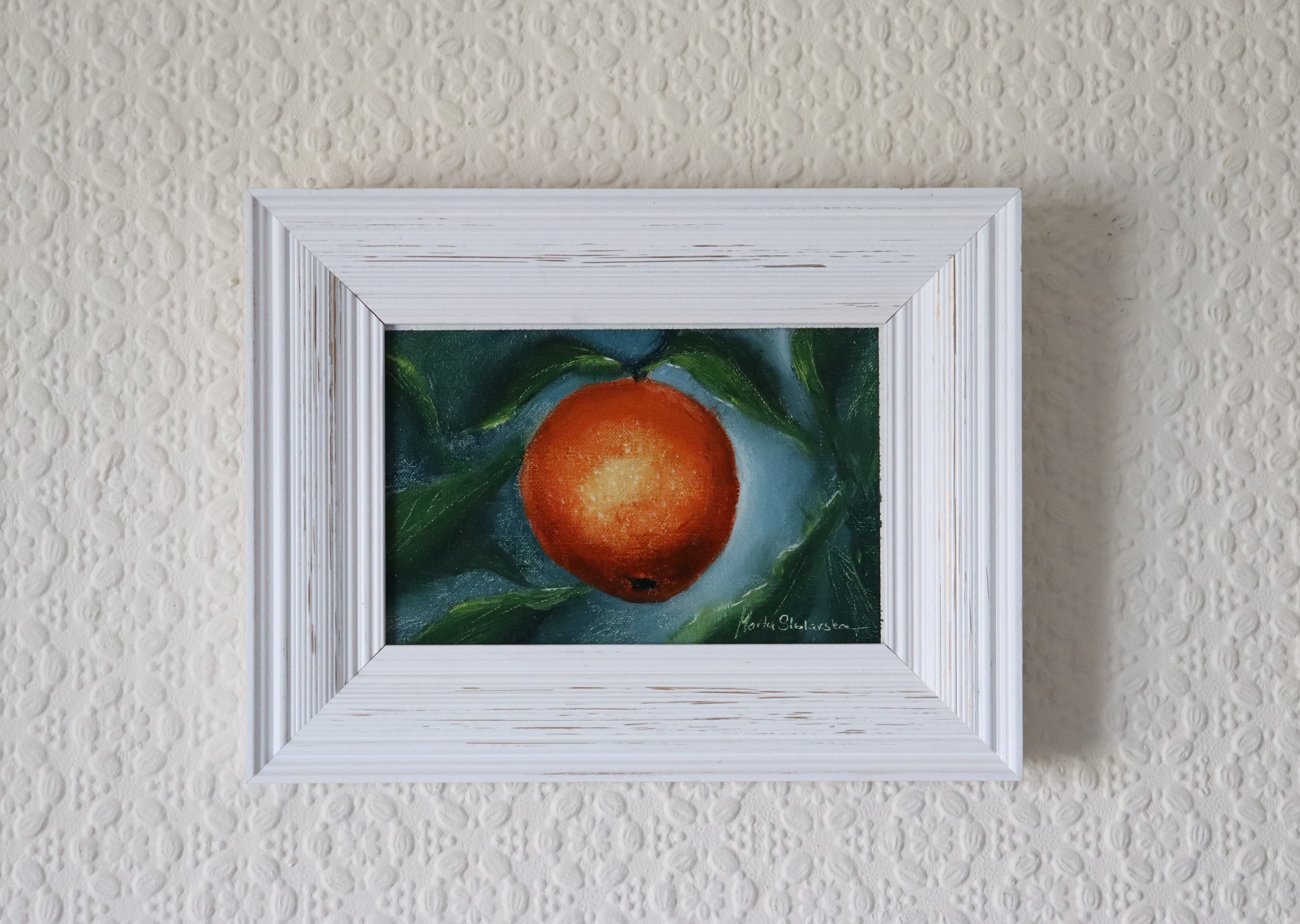 Childhood Scents original oil still life hung on a wall - orange with leaves on dark background in modern white wooden frame, approx. 18.5 x 23.5 cm, by Marta Stolarska Fine Art, ready to hang