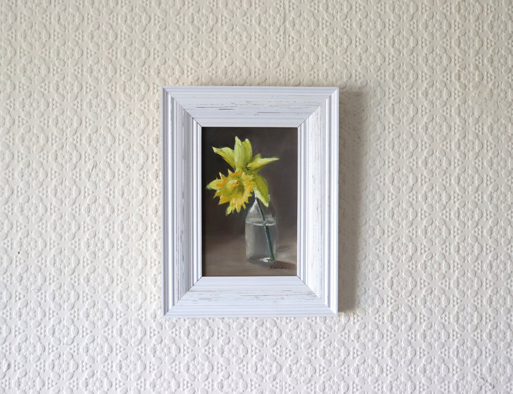One Daffodil is All You Need original oil painting hung on a wall - yellow daffodil in glass bottle in modern white wooden frame, approx. 18.5 x 23.5 cm, by Marta Stolarska Fine Art, ready to hang