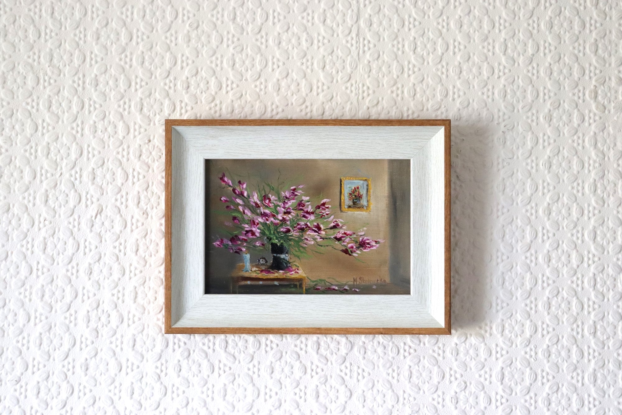 Forgotten in Late Summer Heat original oil painting hung on a wall - sprawling magenta houseplant in natural oak-effect wooden frame, 20 x 15 cm, by Marta Stolarska Fine Art, ready to hang