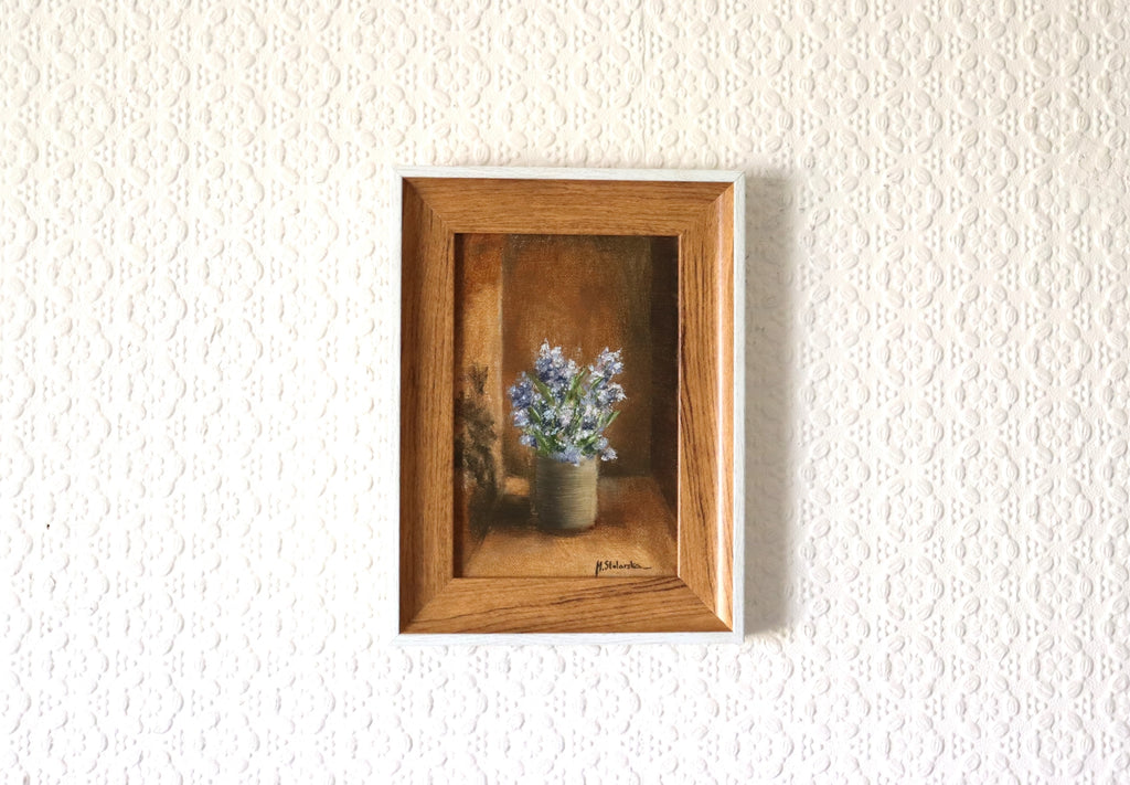 Fragrant Wildflowers original oil painting hung on a wall - blue wildflowers in stoneware pot in natural oak-effect wooden frame, 15 x 20 cm, by Marta Stolarska Fine Art, ready to hang