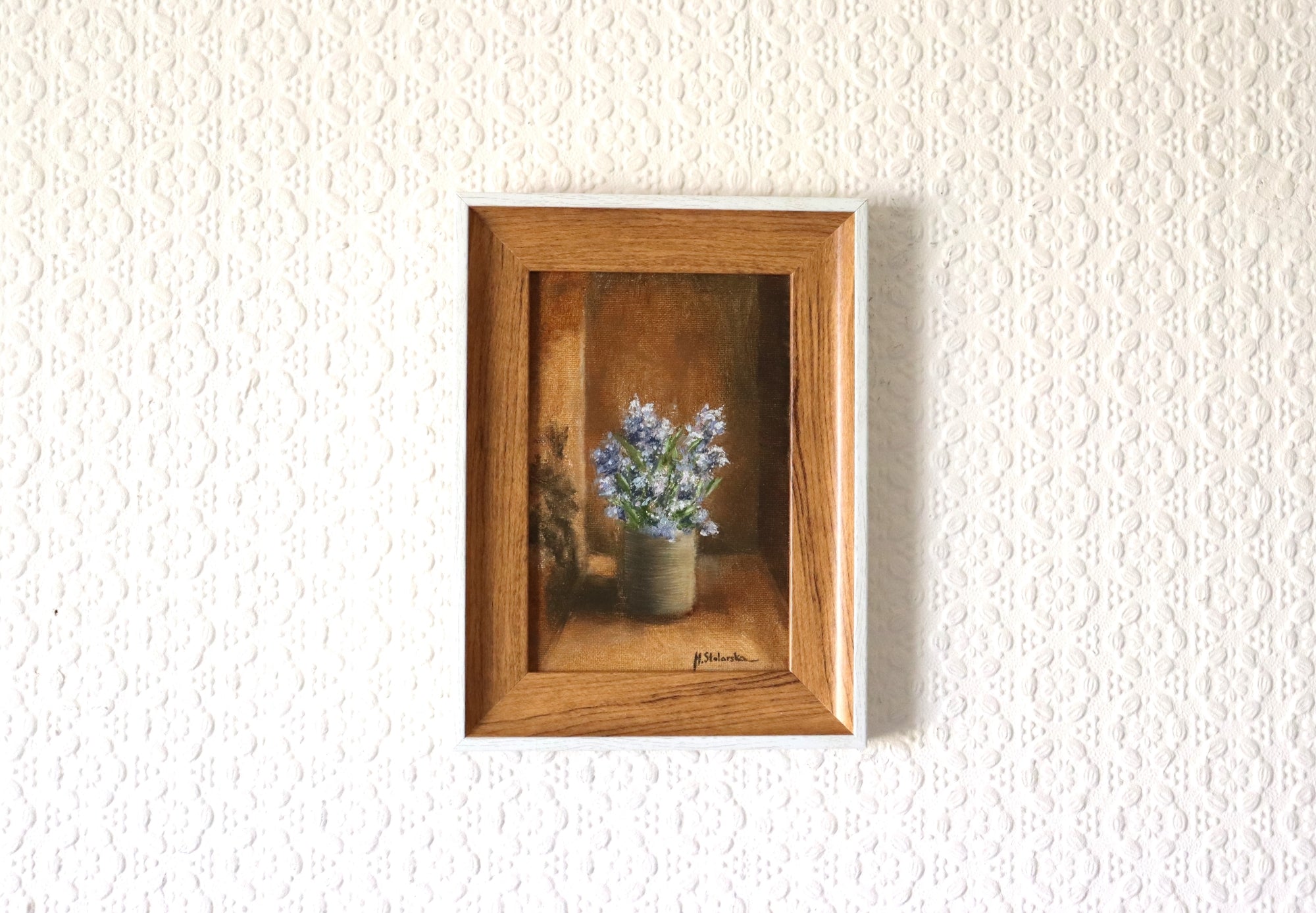 Fragrant Wildflowers original oil painting hung on a wall - blue wildflowers in stoneware pot in natural oak-effect wooden frame, 15 x 20 cm, by Marta Stolarska Fine Art, ready to hang