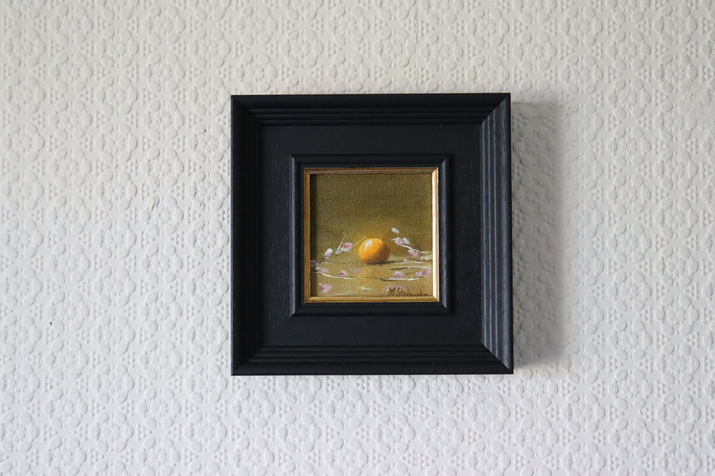 Framed Original oil painting of a glowing orange surrounded by delicate flowers, bold citrus against soft florals