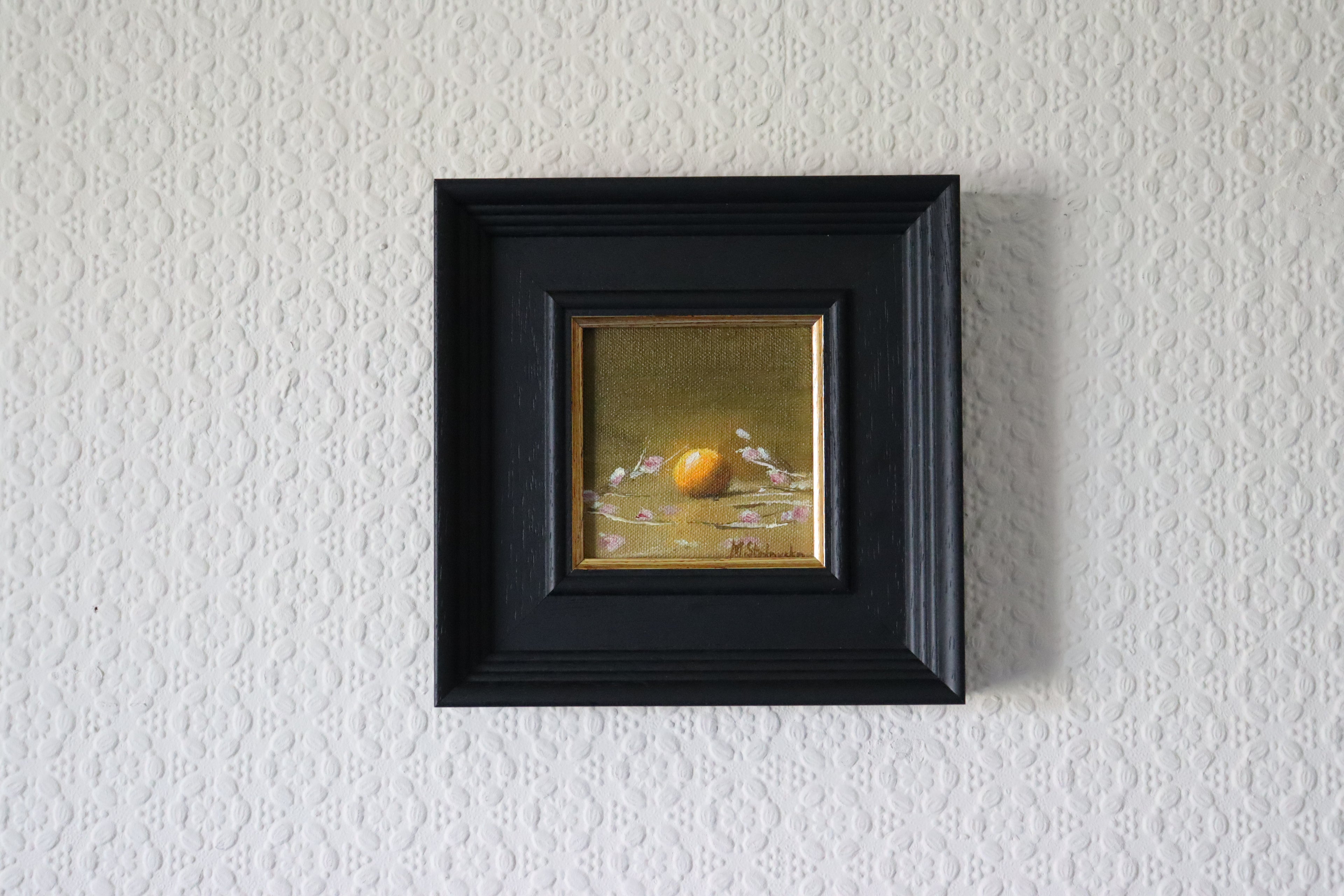 Framed Original oil painting of a glowing orange surrounded by delicate flowers, bold citrus against soft florals