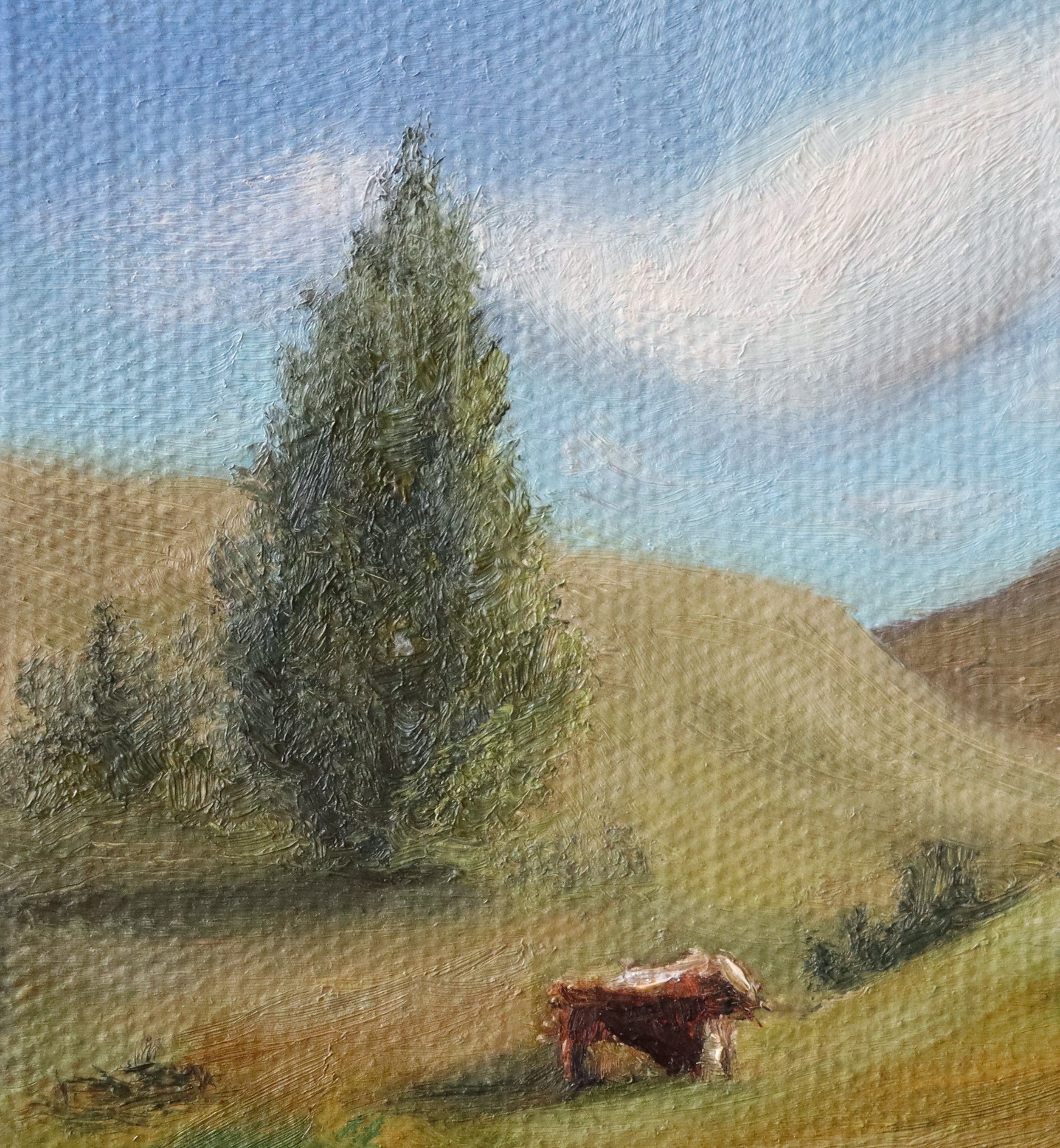 Painting of a cow in a pastoral landscape with trees and hills. Original oil painting of cattle or sheep grazing with a view over open landscape, Suffolk countryside