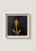 A framed painting of a lit candle on a dark textured background, presented in a light wood frame against a neutral off-white wall.