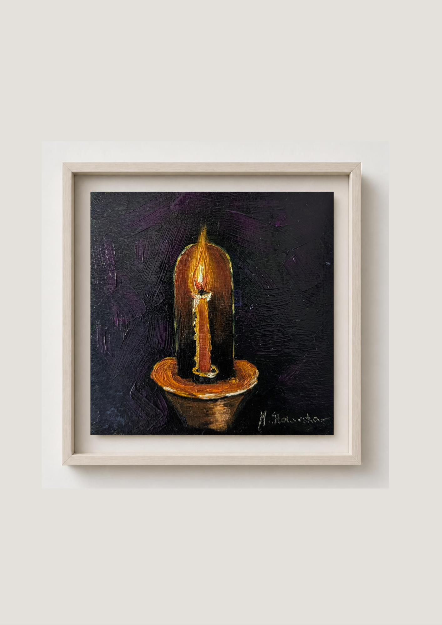 A framed painting of a lit candle on a dark textured background, presented in a light wood frame against a neutral off-white wall.