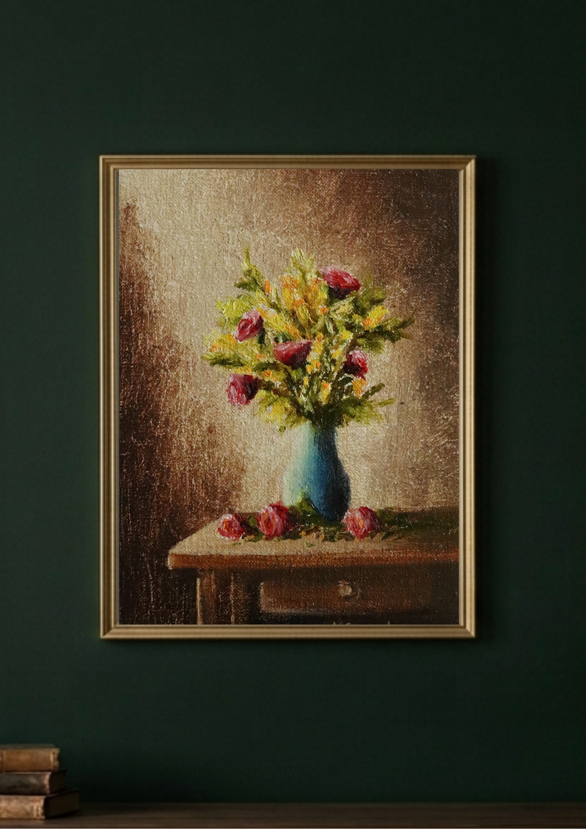 A framed still life painting of a blue vase filled with pink and yellow flowers on a wooden table, displayed on a dark green wall.