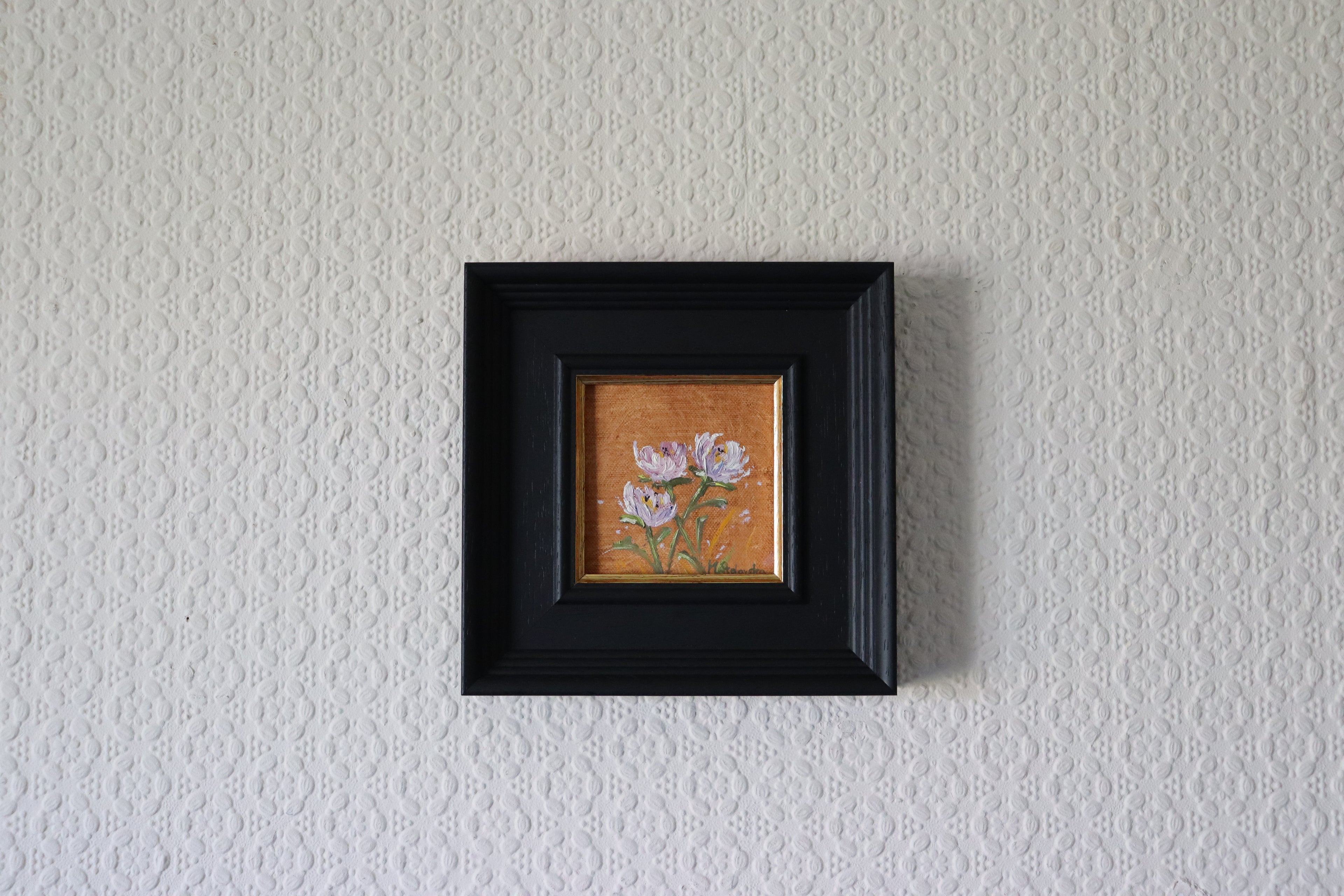 Small framed artwork of flowers on a textured wall. Original oil painting of wildflowers, loose impressionistic floral still life by Marta Stolarska Fine Art