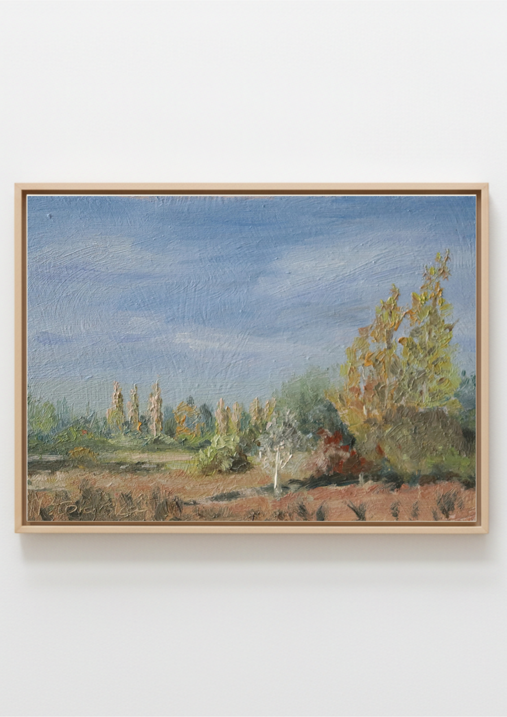 A framed painting on canvas, depicting Scenic landscape with trees and a blue sky. Original oil painting of a path towards the meadows at Carlton Marshes Suffolk, and open fields, hung on a plain white wall.