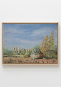 A framed painting on canvas, depicting Scenic landscape with trees and a blue sky. Original oil painting of a path towards the meadows at Carlton Marshes Suffolk, and open fields, hung on a plain white wall.