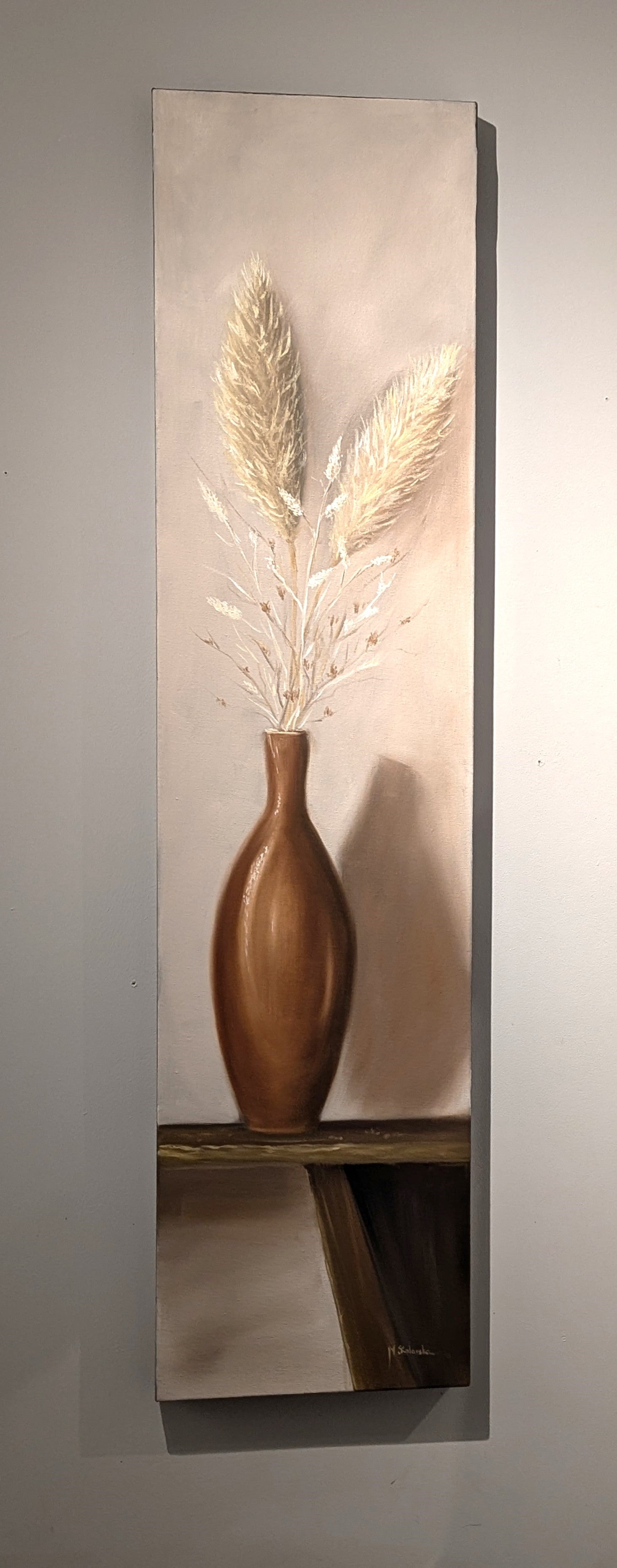 Like a Feather original oil painting hung on a wall with directional lighting - tall 30x122cm deep edge canvas, glazed vase with feather-soft grasses by Marta Stolarska, ready to hang