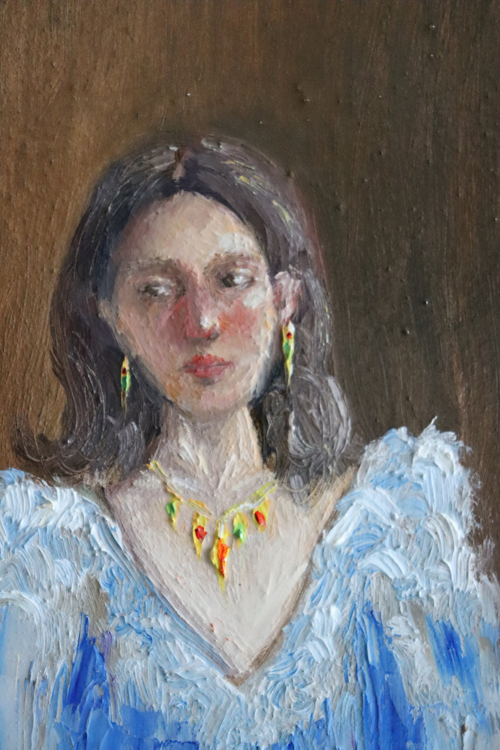 Close-up detail of Lost in Her Thoughts - blushed cheeks and averted gaze of dark-haired woman in blue frill blouse, expressive oil brushwork by Marta Stolarska