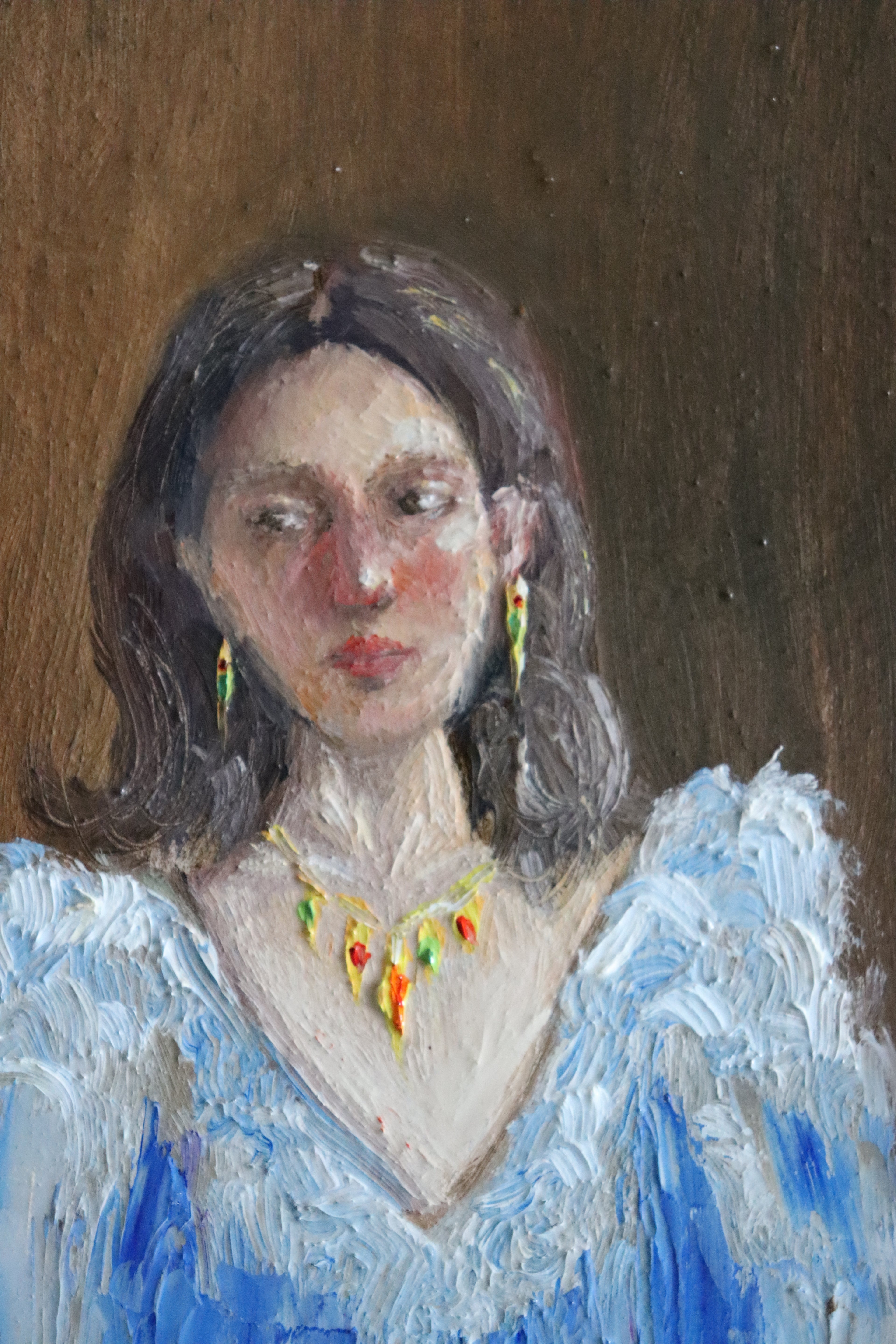 Close-up detail of Lost in Her Thoughts - blushed cheeks and averted gaze of dark-haired woman in blue frill blouse, expressive oil brushwork by Marta Stolarska