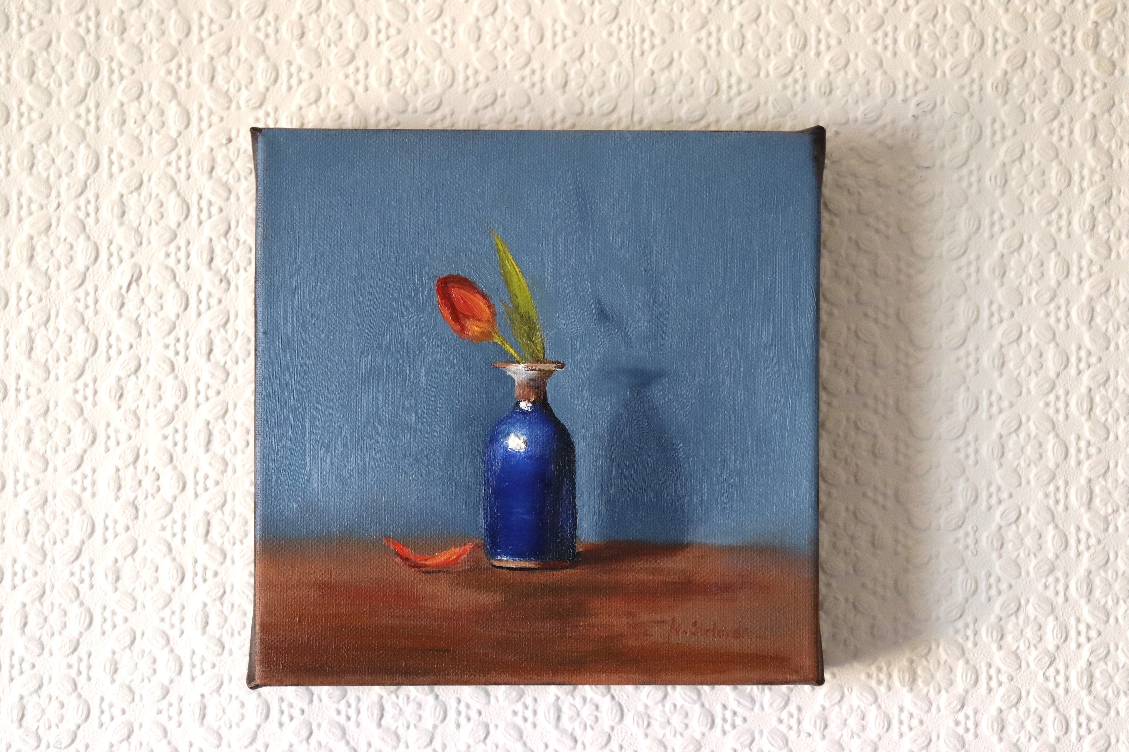 One Petal Gone original oil painting hung on a wall - red tulip with one petal gone in antique blue vase, deep edge canvas 20x20cm by Marta Stolarska Fine Art