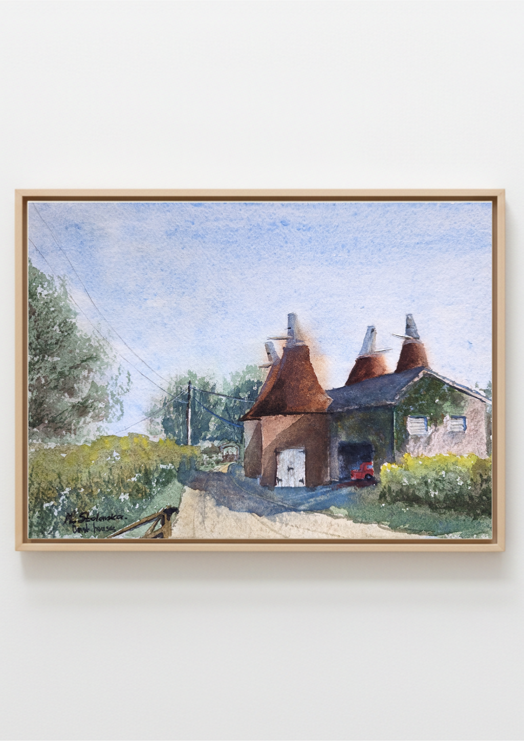 Watercolor painting of a traditional oast house with thatched roofs in a rural setting. Local artist. Original watercolour painting of old oast houses in English countryside, half observed half imagined, Kent landscape