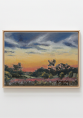 A framed landscape painting featuring a sunset sky with dark blue and orange clouds, silhouetted trees, and a field of pink flowers, displayed against a light gray wall.
