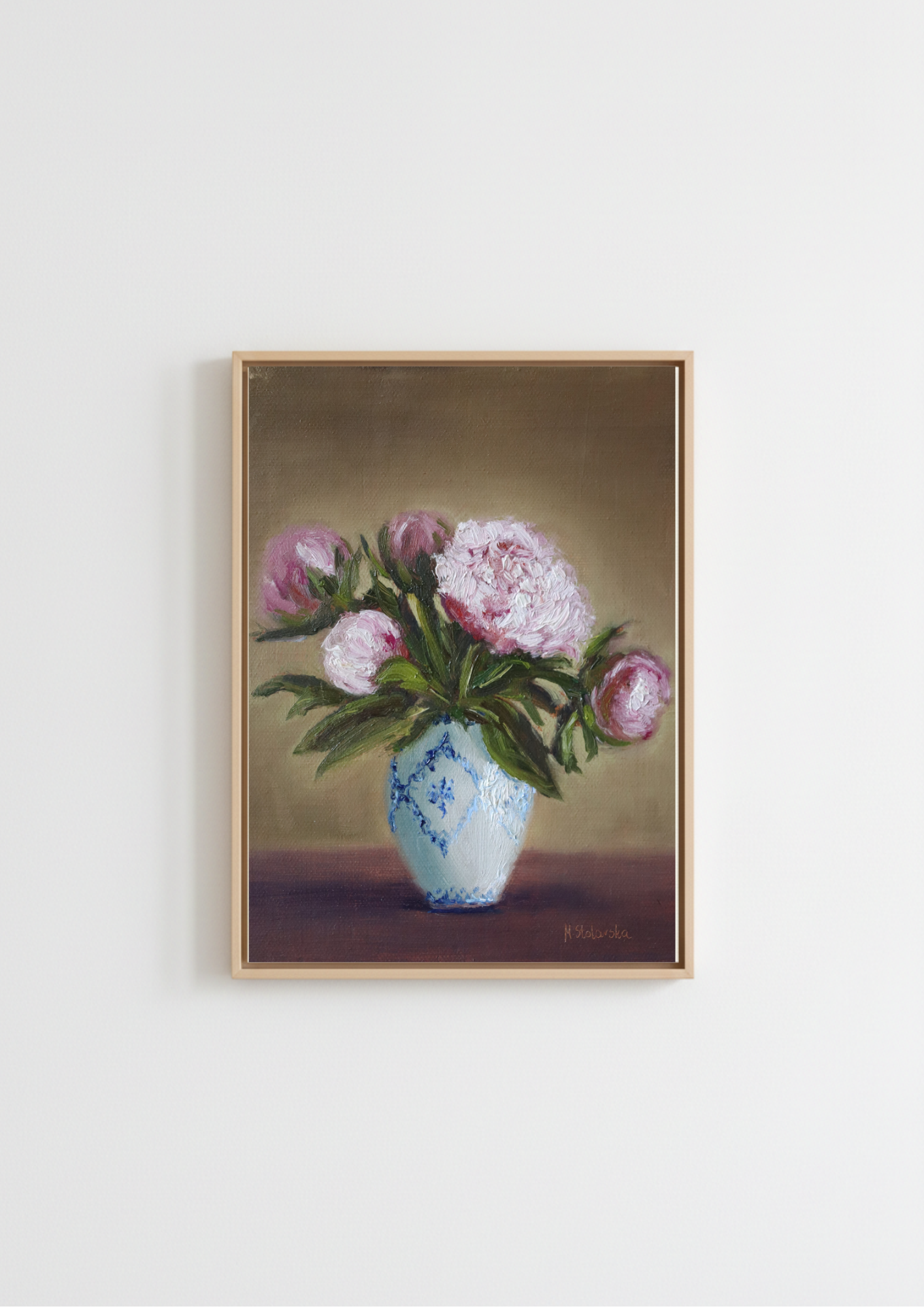 Painting of pink peonies  and a white and blue vase on a table. Original oil painting of five pink peonies in a white vase with blue design, at different stages of bloom