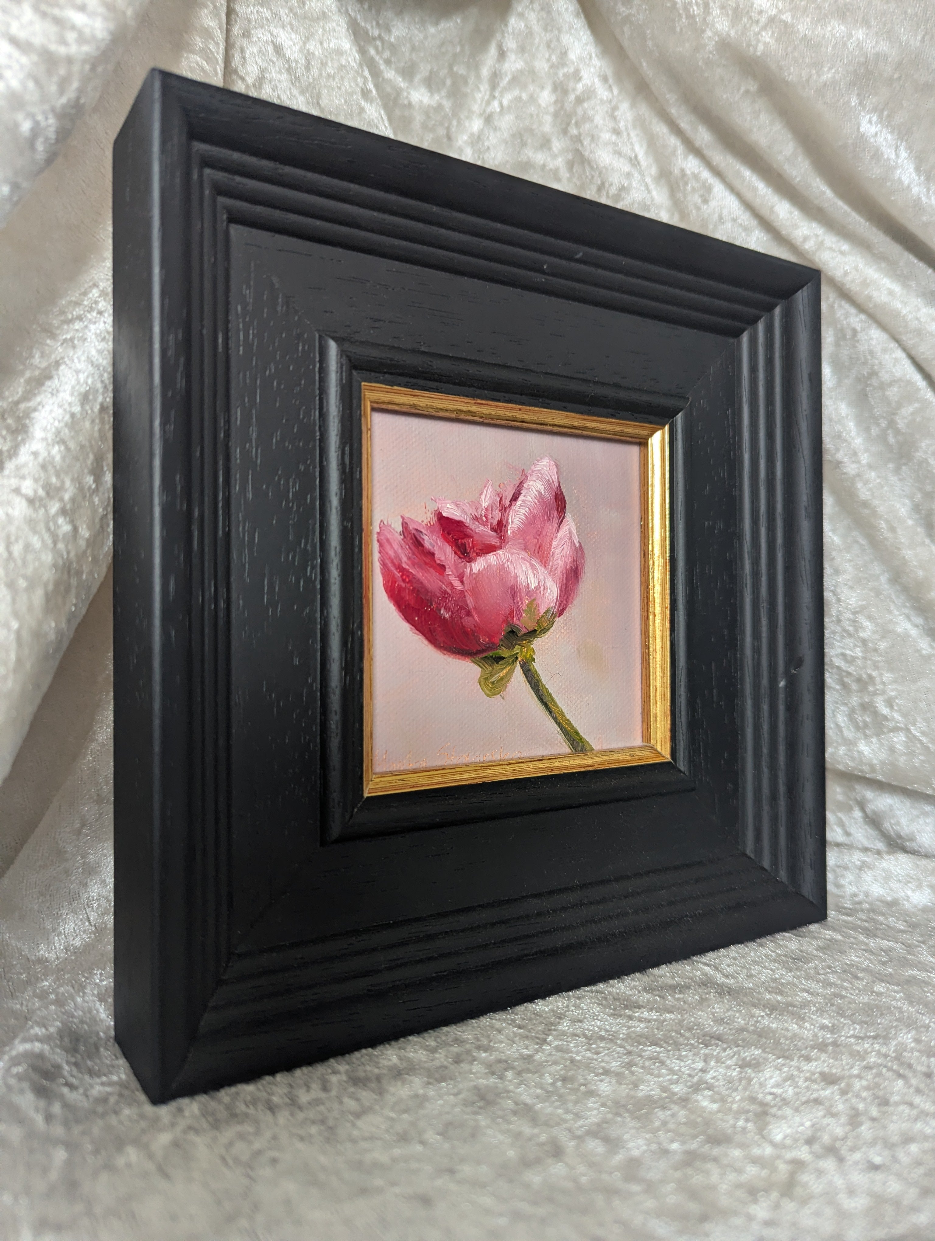 Framed artwork of a pink flower on a textured white background. Original oil painting of a single peony flower, lush petals in a floral still life by Marta Stolarska