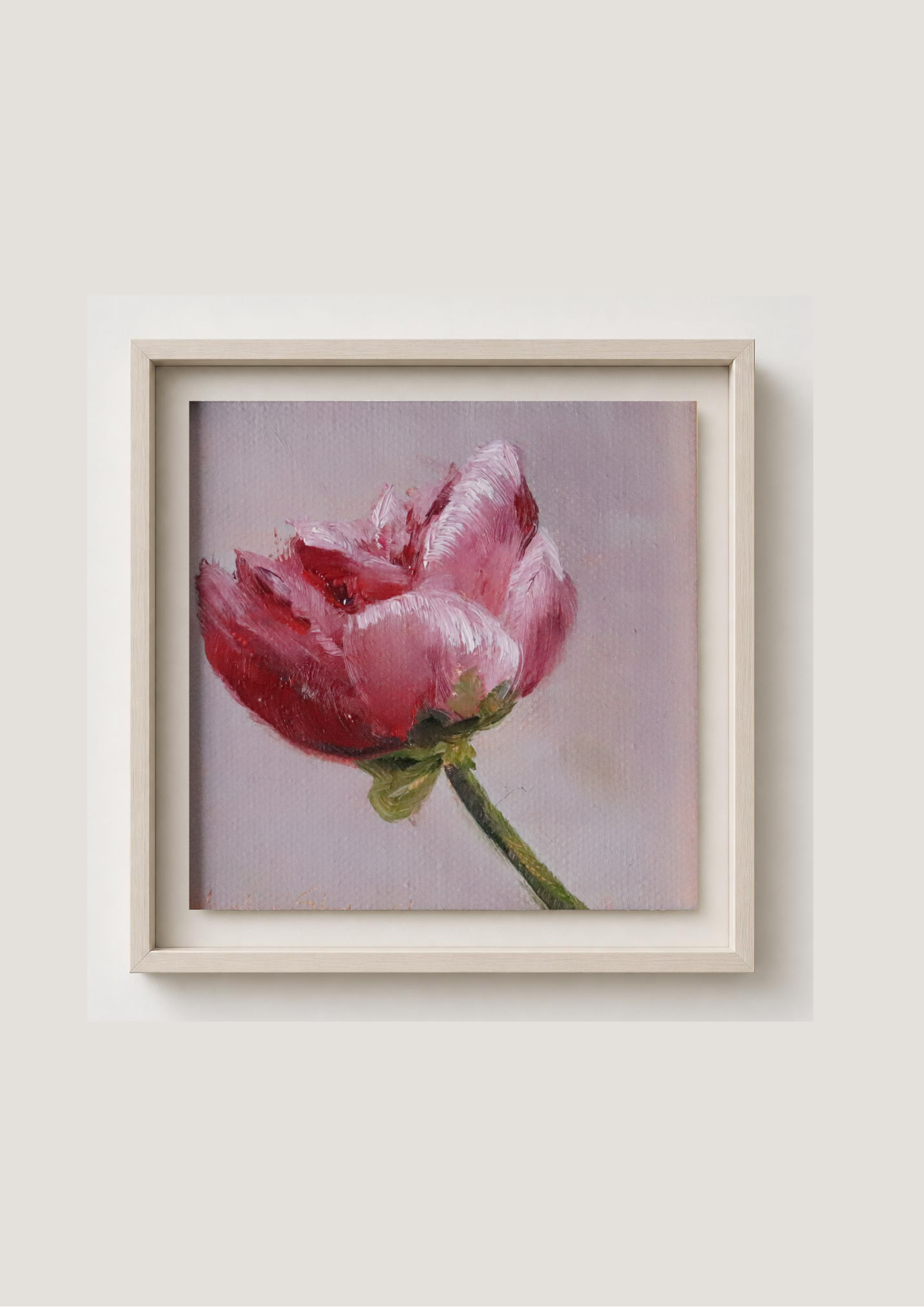 A framed painting of a pink peony on a soft lavender background, presented in a light beige frame against a neutral light gray wall.