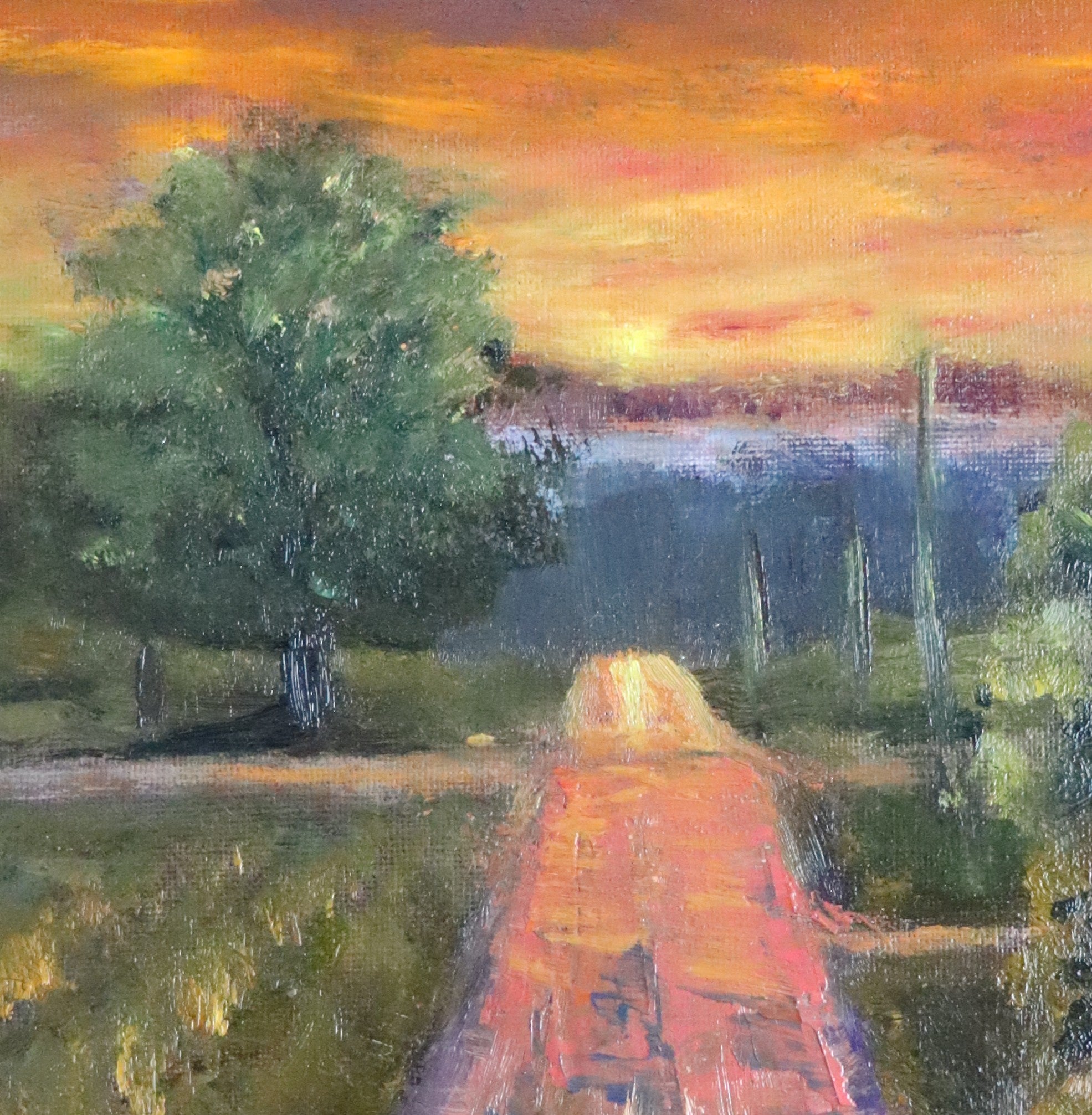 Original oil painting of a wet road glowing with reflected sunset colours after rain, imagined landscape, framed