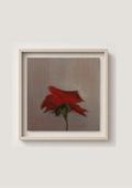 A framed painting of a single red rose with a green stem on a textured gray-brown background, enclosed in a light beige frame and mounted on a light gray wall.