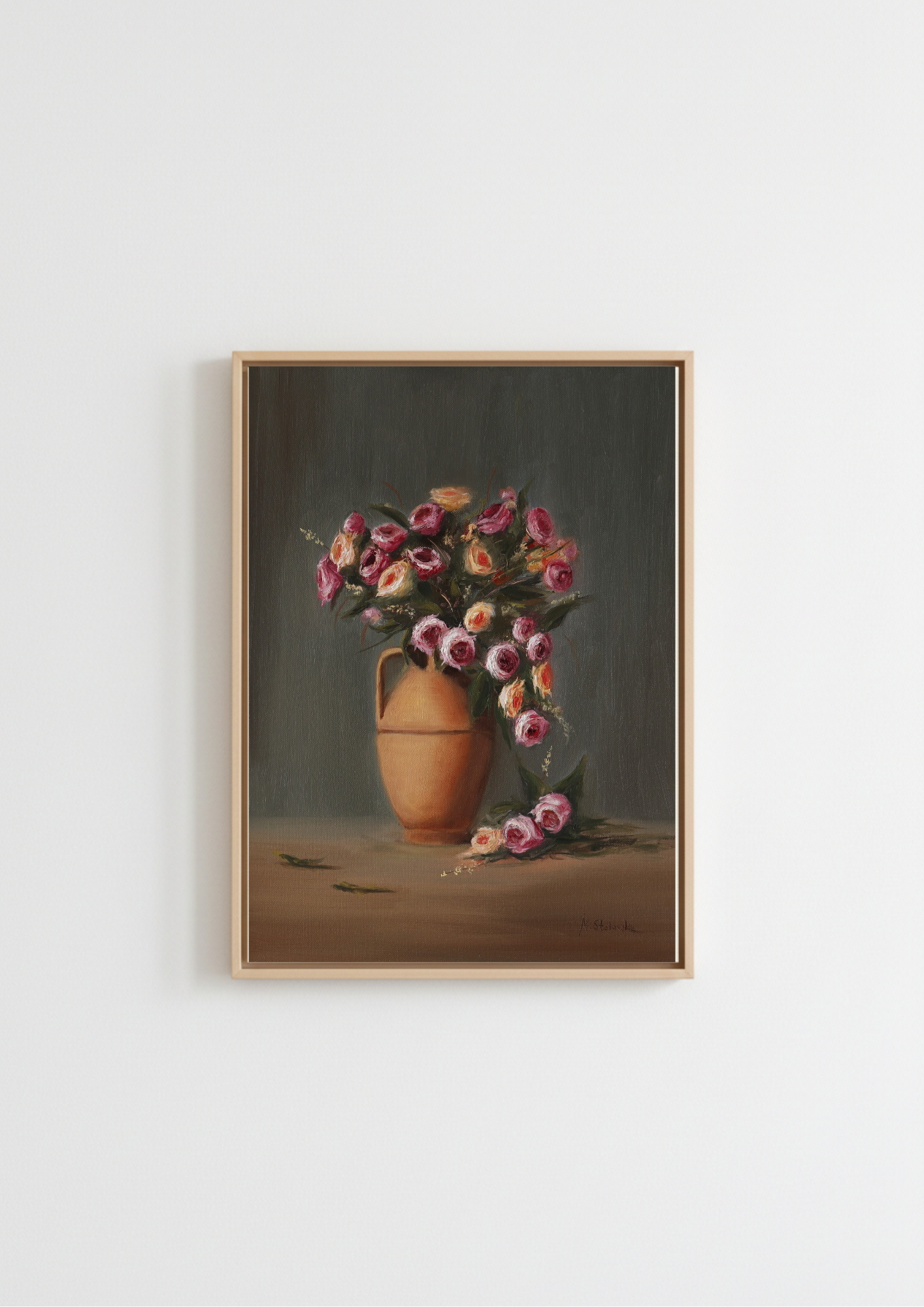 A framed still life painting of a pink and purple flower bouquet in a terracotta vase, hanging on a plain white wall. Original oil painting Rose Magic by Marta Stolarska - patio roses in a terracotta vase with fallen petals, light moving across the composition, 50x40cm on handmade canvas board
