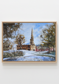 A framed watercolor painting of a church with a tall steeple, surrounded by trees and a snowy foreground, displayed on a light gray wall. Local artist.Original watercolour painting of St Paul's Church Birmingham Jewellery Quarter on a cold bright winter day