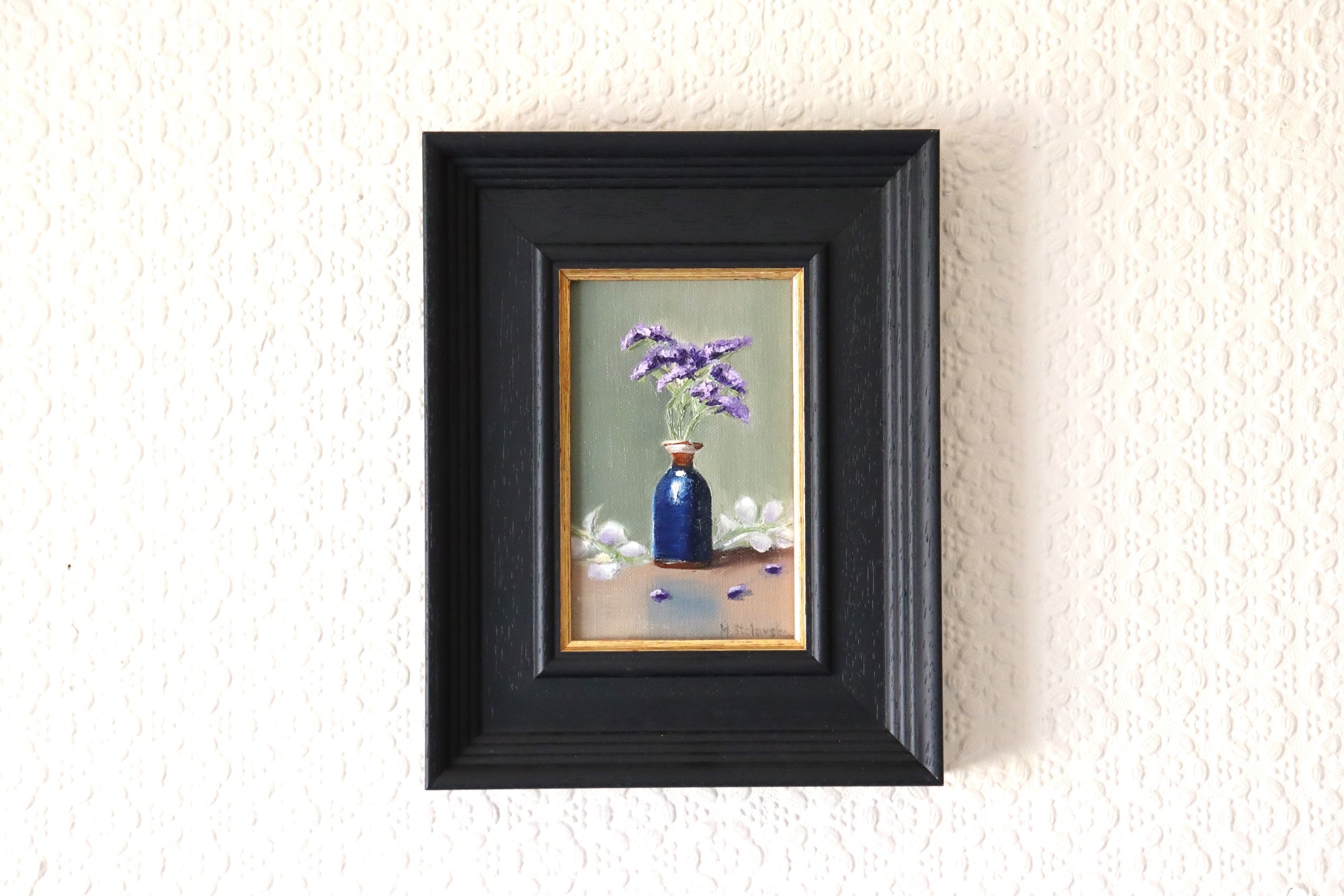 The Forgotten Flowers original oil painting hung on a wall - purple statice in cobalt blue bottle in black wooden box frame with gold inner slip, approx. 18.5 x 23.5 cm, by Marta Stolarska Fine Art