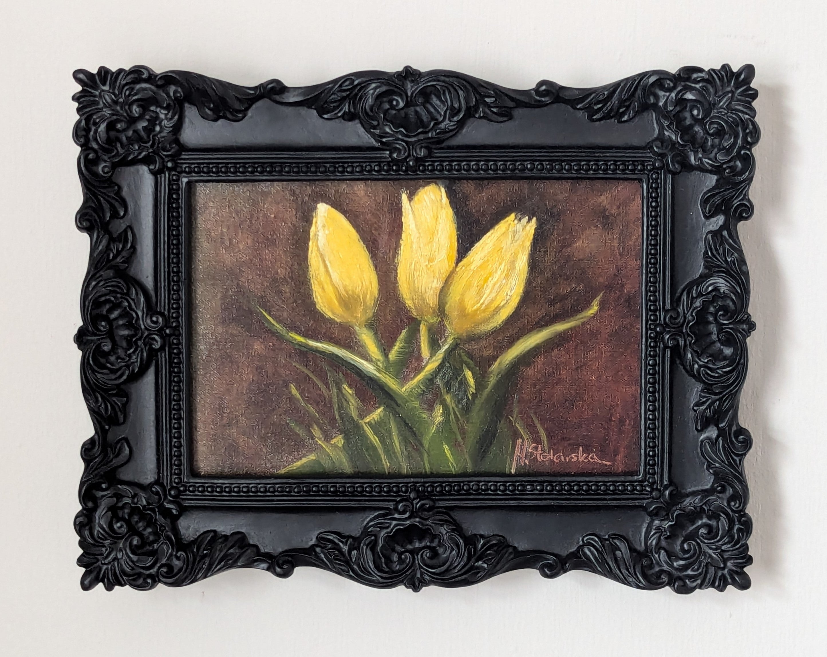 Yellow Tulips Trio original oil painting hung on a wall - three yellow tulips in ornate black frame, approx. 18.5 x 23.5 cm, by Marta Stolarska Fine Art, can hang or stand