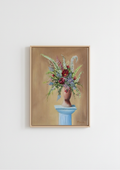 A framed still life painting of a floral bouquet in a blue vase against a warm beige background, hung on a plain white wall. original fine art print, of a floral arrangement. High Quality Fine art Print an affordable way of decorating your walls.