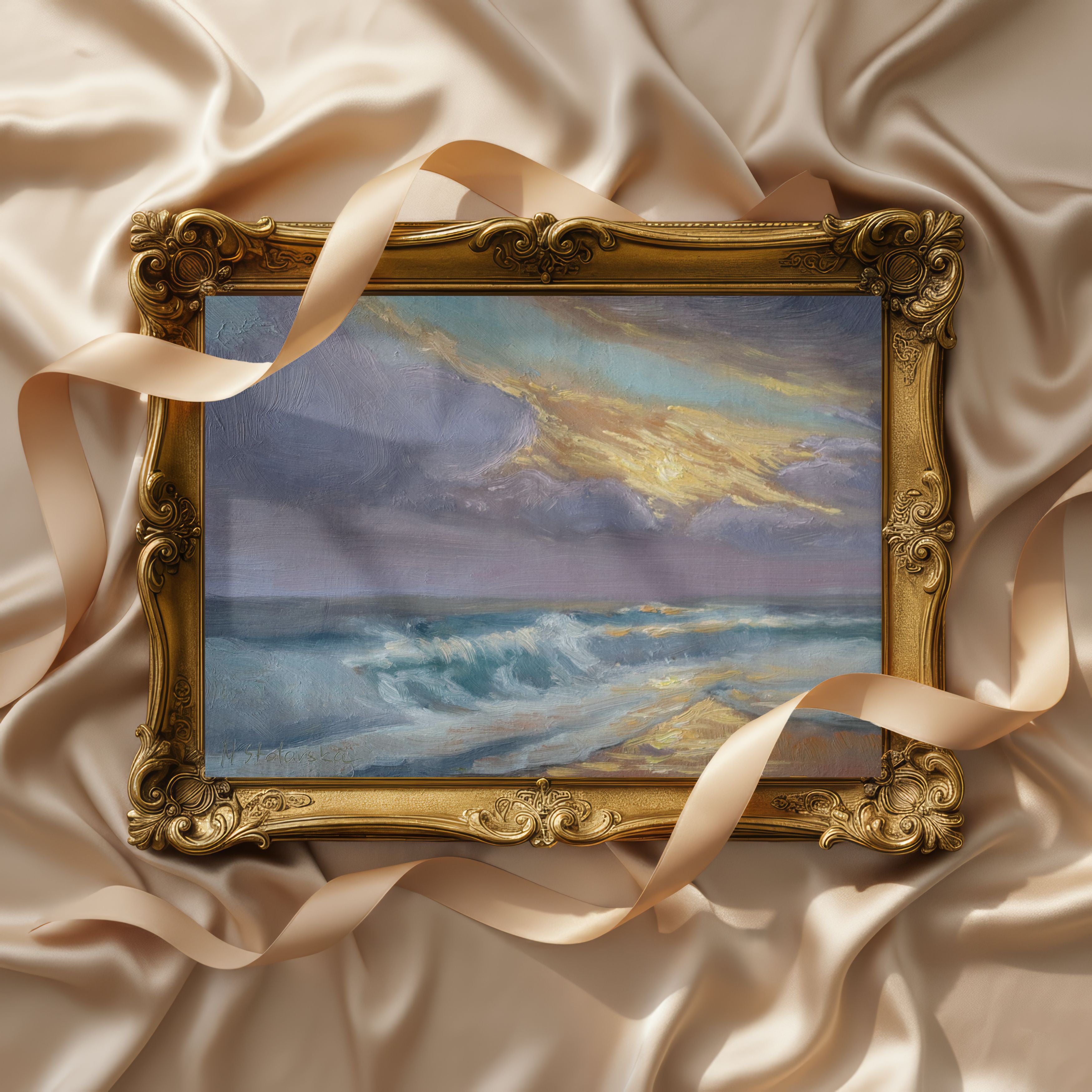 Lifestyle setting of an Original oil painting of sunset at the sea, golden wet sand reflecting setting sun with light shining through rising waves Decorative painting of a beach scene in an ornate gold frame on a textured beige fabric background.