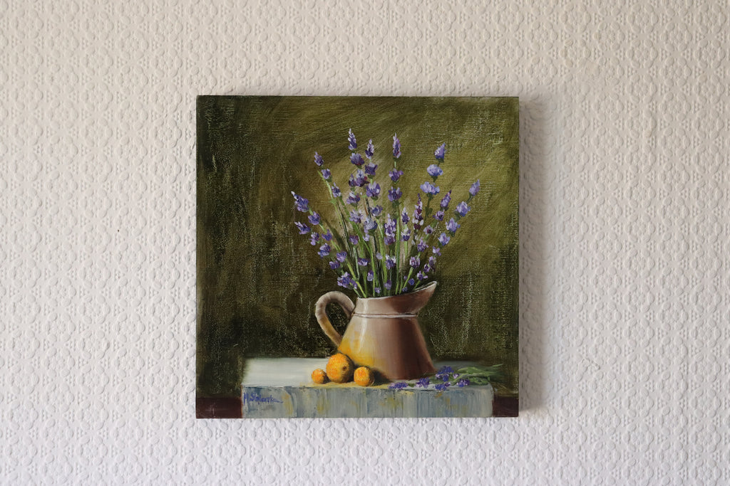 The Lavender Harvest original oil still life hung on a wall - lavender in watering can on grey stone, summer garden painting, 30x30cm cradled wooden panel by Marta Stolarska Fine Art, ready to hang