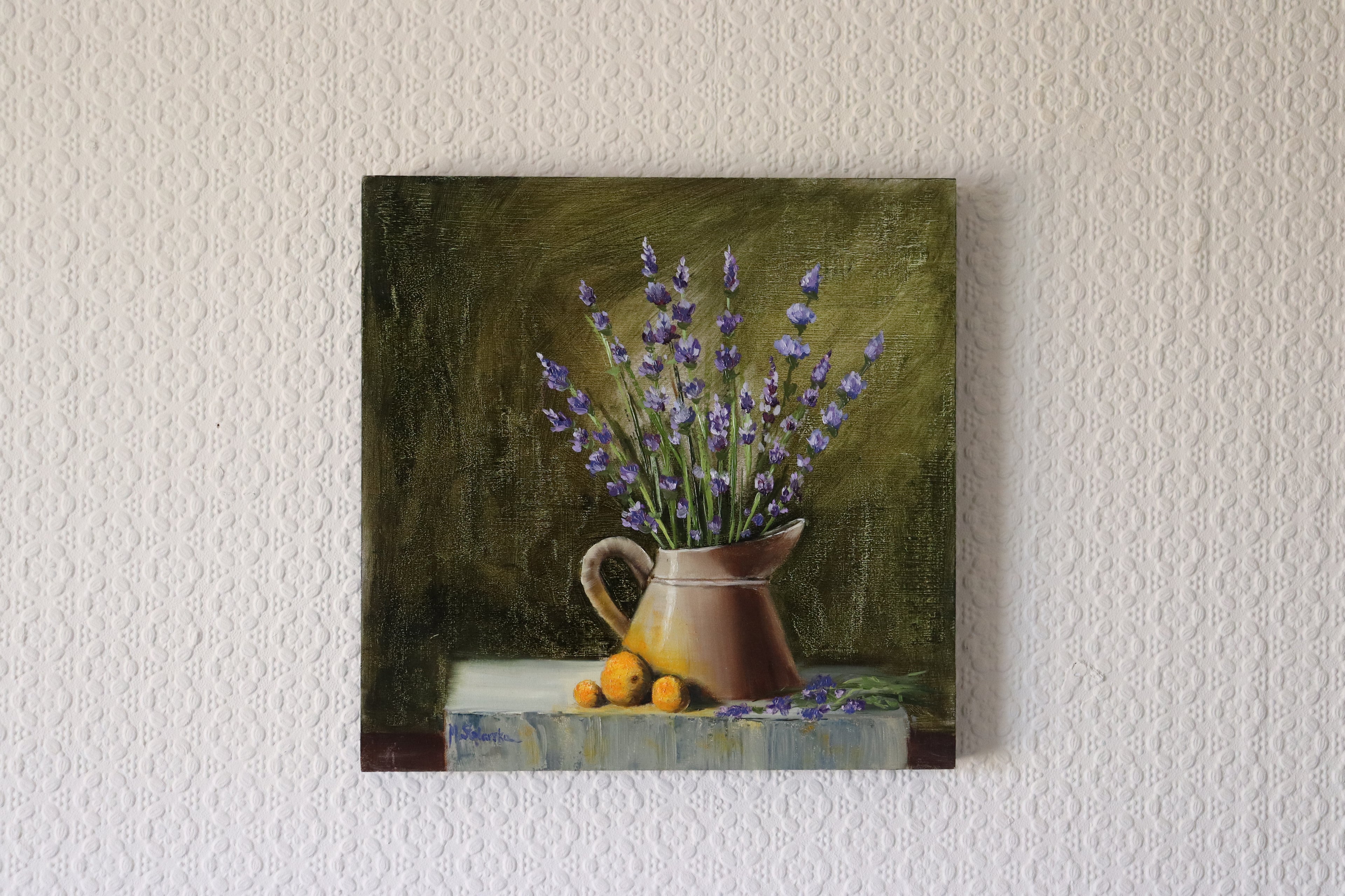 The Lavender Harvest original oil still life hung on a wall - lavender in watering can on grey stone, summer garden painting, 30x30cm cradled wooden panel by Marta Stolarska Fine Art, ready to hang