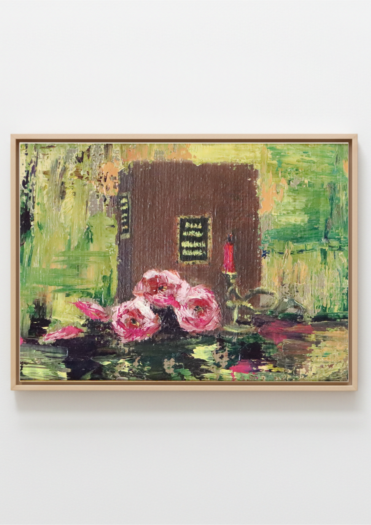 A framed painting on a light gray wall, depicting a brown book with a small red candle and pink flowers in the foreground against a textured green and yellow background.Still life painting with pink flowers and a candle on a reflective surface. Original painting The Book of Spells, mysterious atmospheric artwork by Marta Stolarska Fine Art 