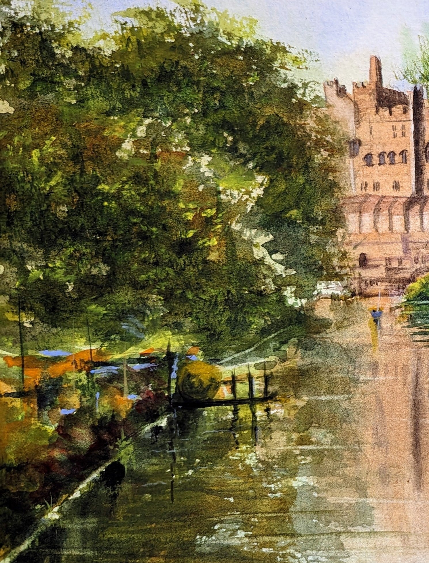 Painting of a castle by a river with trees in the foreground. Castle by a river with lush greenery. Work by a local artist. Original watercolour painting of Warwick Castle from the River Avon Warwickshire, medieval fortress built 1068