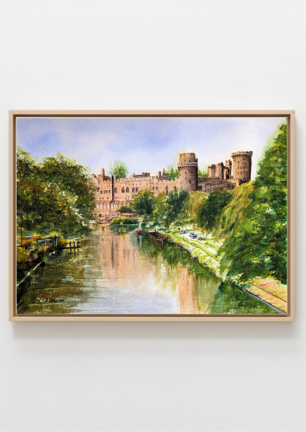 A framed print landscape of a canal with green trees, a stone castle, and reflections in the water, shown against a light gray wall. Warwick Castle - limited edition A3 fine art print by Marta Stolarska, based on original watercolour, 312gsm archival matt cotton paper, edition of 50, hand signed and numbered