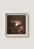 A framed still life painting featuring pink and red flowers in a white vase against a dark brown background, enclosed in a light beige frame and mounted on a light gray wall. Where the Light Falls - original oil painting by Marta Stolarska, rose arrangement in white and blue vase with fallen roses on table, light moving across composition, 20x20cm deep edge canvas