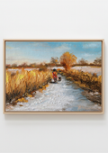 A framed landscape painting depicting a snowy path leading through golden fields toward a tree, with a small figure in red near the center, shown against a plain light gray background. Painting of a rural scene with a person on a bike and a dog, surrounded by fields and trees by a local artist. Original oil painting of a winter walk at Suffolk marshes, snow-covered landscape with figures