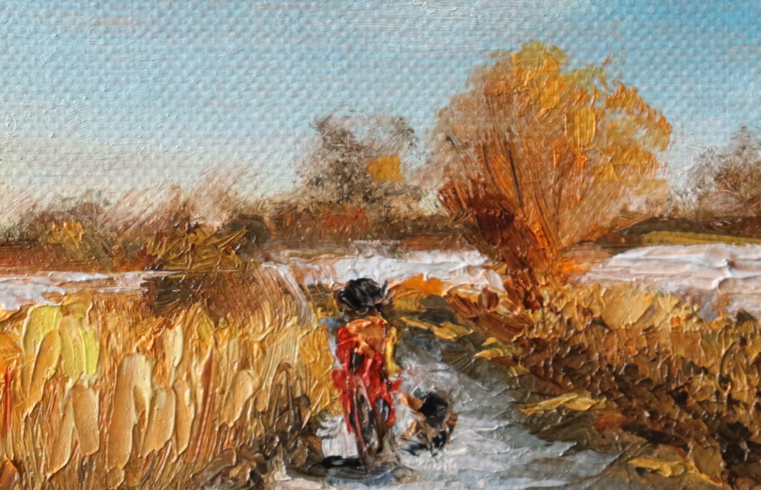 Painting of a rural scene with a person on a bike and a dog, surrounded by fields and trees by a local artist. Original oil painting of a winter walk at Suffolk marshes, snow-covered landscape with figures