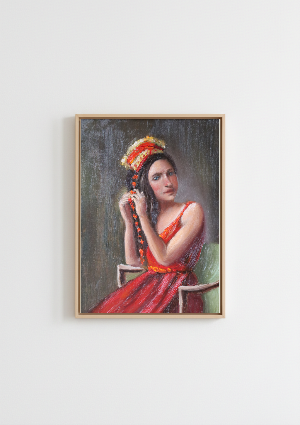 A framed portrait painting of a woman in a red dress and ornate headpiece, hanging on a plain white wall. Woven in Tradition - original oil figure painting by Marta Stolarska, woman in red dress and fringed satin shawl braiding a red velvet string, looking directly at viewer with joyous blue eyes, oil on canvas board