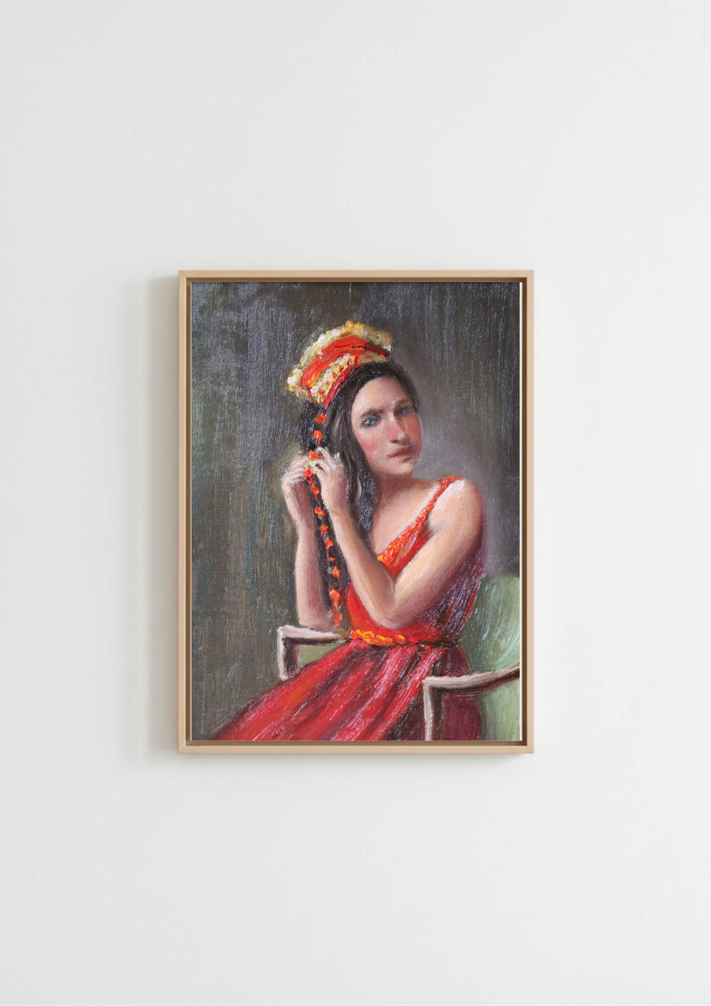 A framed portrait painting of a woman in a red dress and ornate headpiece, hanging on a plain white wall. Woven in Tradition - original oil figure painting by Marta Stolarska, woman in red dress and fringed satin shawl braiding a red velvet string, looking directly at viewer with joyous blue eyes, oil on canvas board