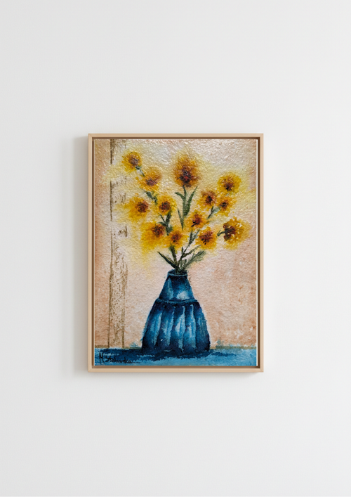 Framed wall art featuring a textured painting of yellow sunflowers in a blue vase, displayed on a clean white wall.
